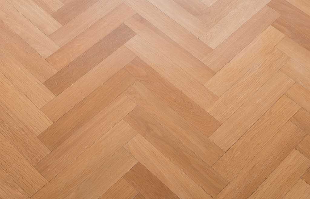 wooden floor - herringbone parquet closeup - oak parquet - wooden floor - herringbone parquet closeup - oak parquet